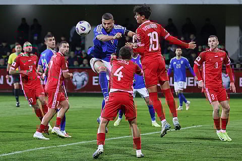 Italy's Alessandro Bunongiorno, left, jumps for a header with Moldova's Daniel Dumbravanu during a group 1, World Cup qualifier soccer match between Moldova and Italy in Chisinau, Moldova.