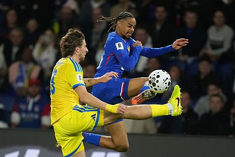 France's Bradley Barcola fights for the ball against Ukraine's Illia Zabarnyi during a World Cup 2026 group D qualifying soccer match between France and Ukraine in Paris.
