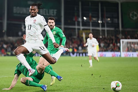 Portugal's Rafael Leao, top, duels for the ball with Ireland's Seamus Coleman during a World Cup 2026 group F qualifying soccer match between Ireland and Portugal in Dublin.
