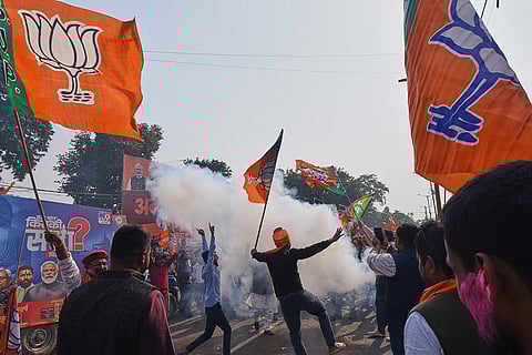 Supporters of Bharaiya Janata party celebrate the early leads in Bihar state election results in Patna.