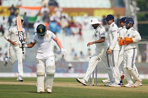 Indian players celebrate as South Africa's captain Temba Bavuma, left, reacts after losing his wicket on the first day of the first cricket test match between India and South Africa in Kolkata.