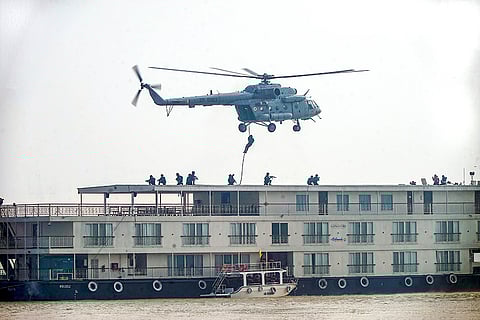 National Security Guard (NSG) and Anti-Terror Squad (ATS) personnel conduct a mock drill aboard a cruise ship in the middle of Ganga river, in Varanasi, Uttar Pradesh.