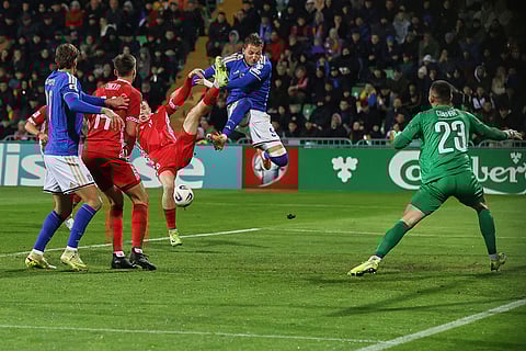Italy's Mateo Retegui attempts to score next to Moldova's Daniel Dumbravanu during a group 1, World Cup qualifier soccer match between Moldova and Italy in Chisinau, Moldova.