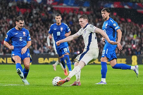 England's Elliot Anderson sends a cross by Serbia's Ognjen Mimovic during a World Cup qualifier group K soccer match between Serbia and England in London.