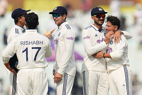 India's Kuldeep Yadav, right, celebrates with teammates after the dismissal of South Africa's Wiaan Mulder on the first day of the first cricket test match between India and South Africa in Kolkata.