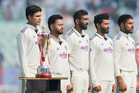 India's captain Shubman Gill, left, and teammates stand for their national anthem prior to the start of the first cricket test match between India and South Africa in Kolkata.