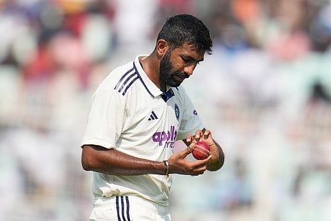 India's Jasprit Bumrah prepares to bowl his next delivery on the first day of the first cricket test match between India and South Africa in Kolkata.