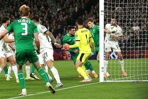 Ireland's Troy Parrott (7) scores the opening goal during a World Cup 2026 group F qualifying soccer match between Ireland and Portugal in Dublin.