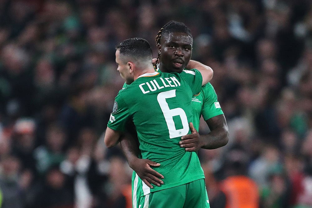 Ireland's Festy Ebosele and Ireland's Josh Cullen celebrate at the end of a World Cup 2026 group F qualifying soccer match between Ireland and Portugal in Dublin. - | Photo: AP/Peter Morrison