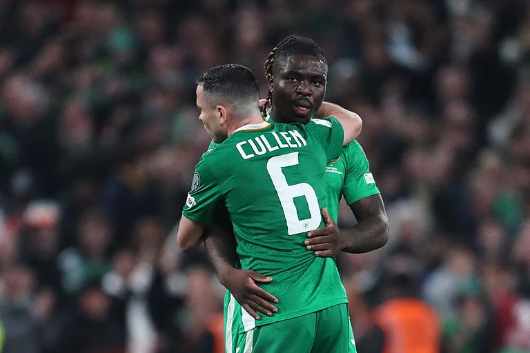 Ireland's Festy Ebosele and Ireland's Josh Cullen celebrate at the end of a World Cup 2026 group F qualifying soccer match between Ireland and Portugal in Dublin. - | Photo: AP/Peter Morrison