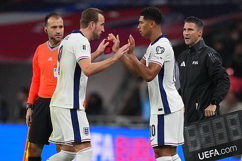 England's Harry Kane, left, is substituted by Jude Bellingham during a World Cup qualifier group K soccer match between Serbia and England in London.
