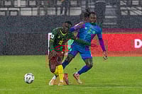 Cameroon 0-1 DR Congo, FIFA World Cup CAF Qualifiers: Mbemba's Late Strike Stuns Indomitable Lions | Photo: AP : Congo's Aaron Wan-Bissaka challenges Cameroon's Arthur Avom Ebong during their FIFA 2026 soccer World Cup African qualifiers semi final, in Rabat, Morocco.