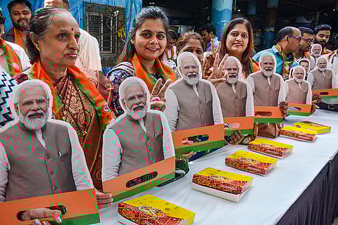 BJP workers celebrate the NDA's strong lead in the Bihar Assembly election, at the party office, in Thane, Maharashtra.