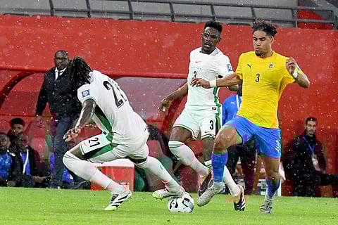 Nigeria's Calvin Bassey, left, and Gabon's Anthony Oyono, right, challenge for the ball during the World Cup 2026 African qualifying semi-final soccer match between Nigeria and Gabon, in Rabat, Morocco.