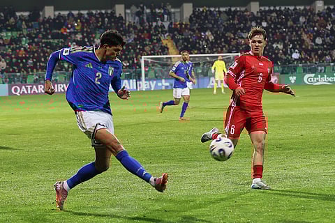 Italy's Raoul Bellanova passes the ball next to Moldova's Stefan Bitca during a group 1, World Cup qualifier soccer match between Moldova and Italy in Chisinau, Moldova.