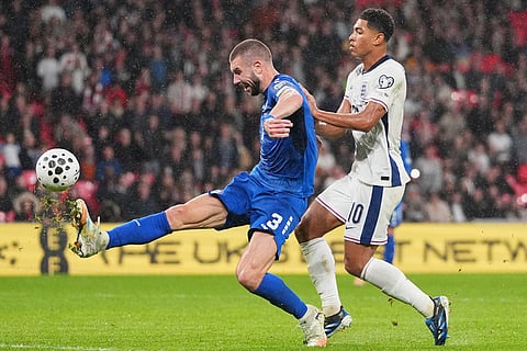 Serbia's Strahinja Pavlovic clears the ball in front of England's Jude Bellingham during a World Cup qualifier group K soccer match between Serbia and England in London.