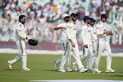 Indian players walk off the field for lunch on the first day of the first cricket test match between India and South Africa in Kolkata.
