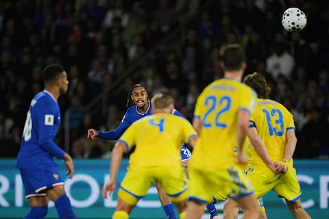 France's Bradley Barcola fights for the ball against Ukraine's Illia Zabarnyi and Oleksandr Svatok during a World Cup 2026 group D qualifying soccer match between France and Ukraine in Paris.