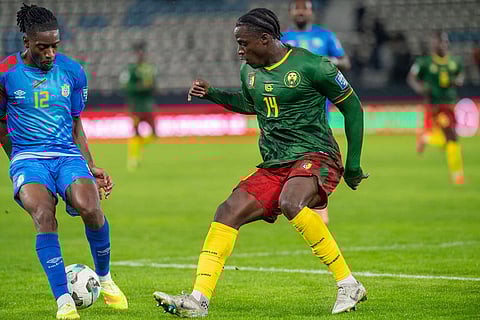 Congo's Joris Kayembe, left, and Cameroon's Etta Eyong battle for the ball during a World Cup qualifying soccer match against Cameroon in Rabat, Morocco. 