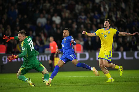 France's Kylian Mbappe scores his side's third goal during a World Cup 2026 group D qualifying soccer match between France and Ukraine in Paris.