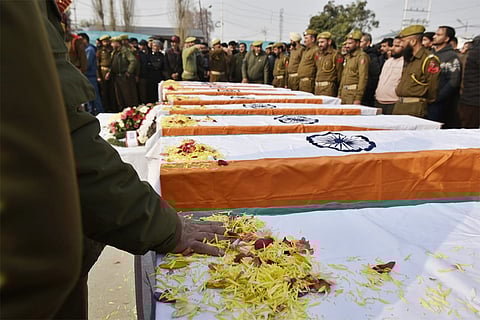 The coffins of the deceased during the wreath-laying ceremony.