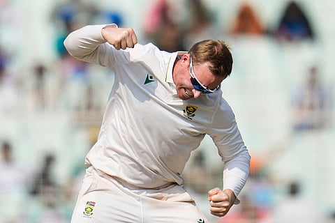 South Africa's Simon Harmer celebrates the dismissal of India's Ravindra Jadeja on the second day of the first cricket test match between India and South Africa in Kolkata.
