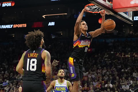 Phoenix Suns forward Oso Ighodaro (11) dunks over Indiana Pacers forward Jeremiah Robinson-Earl during the first half of an NBA basketball game in Phoenix. 