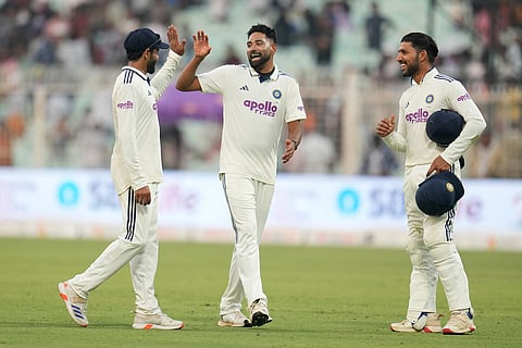 India's Ravindra Jadeja, left, celebrates with teammates Mohammed Siraj, center, and Dhruv Jurel at the end of play on the second day of the first cricket test match between India and South Africa in Kolkata.