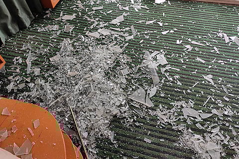 Broken pieces of glass scattered in a room of an adjacent building that was damaged by the accidental explosion at the Nowgam Police Station in Srinagar.