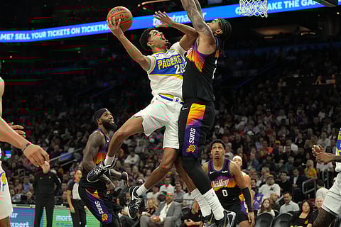 Indiana Pacers guard Ben Sheppard (26) drives against Phoenix Suns center Nick Richards, center right, during the second half of an NBA basketball game in Phoenix. 