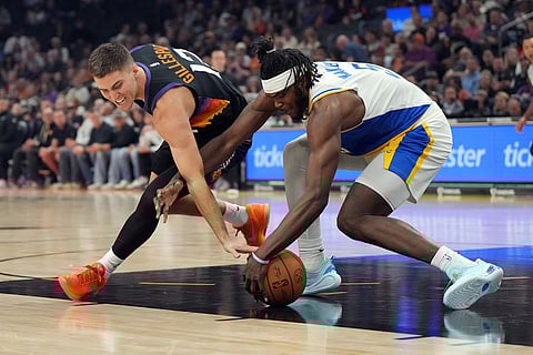 Phoenix Suns guard Collin Gillespie and Indiana Pacers forward Jarace Walker (5) fight for the loose ball during the first half of an NBA basketball game in Phoenix. 