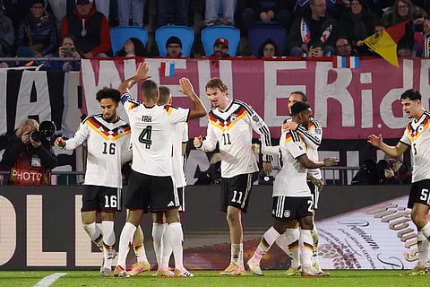 Germany's Nick Woltemade, center, is congratulated after scoring his sides second goal during the 2026 World Cup group A qualifying soccer match between Luxembourg and Germany in Luxembourg.