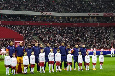 The Netherlands players stand during the national anthems before a World Cup 2026 group G qualifying soccer match between Poland and the Netherlands in Warsaw.