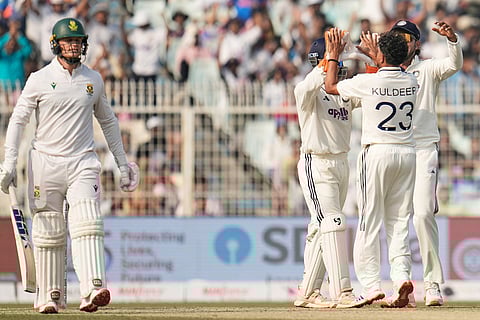 India's Kuldeep Yadav (23) celebrates with teammates after the dismissal of South Africa's Ryan Rickelton, left, on the second day of the first cricket test match between India and South Africa in Kolkata.