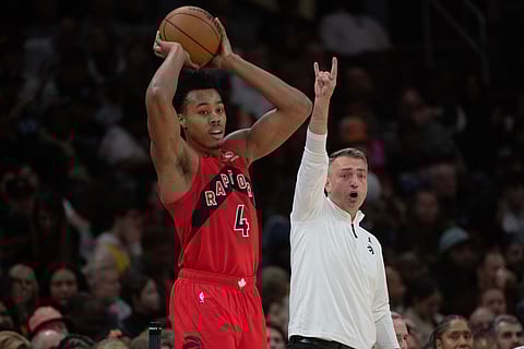 Toronto Raptors' Scottie Barnes (4) prepares to inbound the ball as head coach Darko Rajakovic, right, calls directions during the second half of an NBA basketball game against the Cleveland Cavaliers in Cleveland.