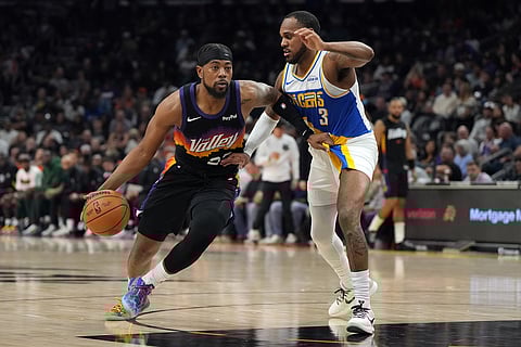 Phoenix Suns guard Jordan Goodwin (23) drives on Indiana Pacers guard Monte Morris during the first half of an NBA basketball game in Phoenix.