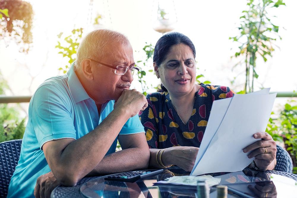 Older couple reviewing documents outdoors