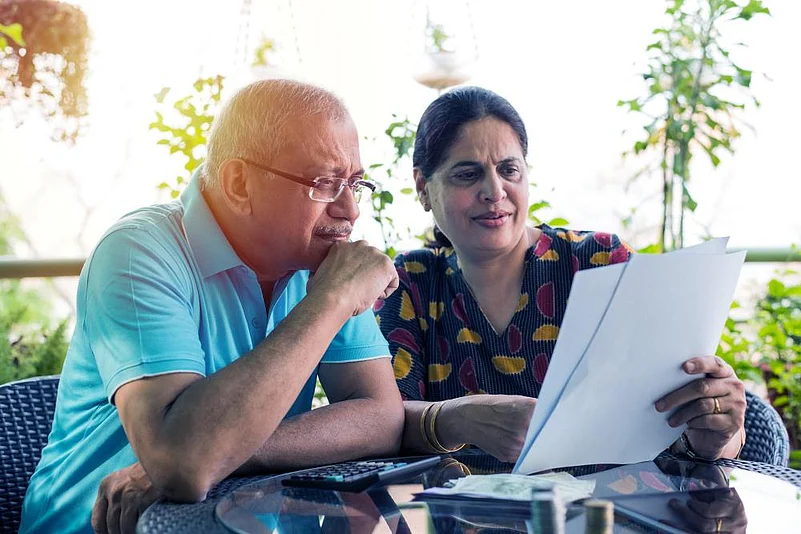 Older couple reviewing documents outdoors