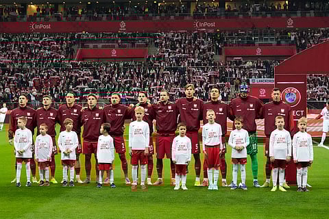 Poland players stand during the national anthems before a World Cup 2026 group G qualifying soccer match between Poland and the Netherlands in Warsaw.