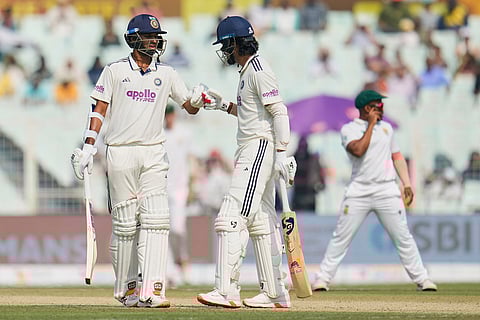 India's Washington Sundar, left, and batting partner KL Rahul celebrate scoring runs on the second day of the first cricket test match between India and South Africa in Kolkata.