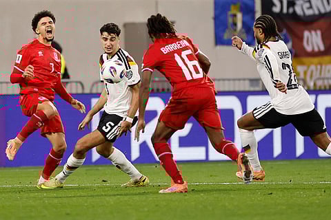 Luxembourg's Aiman Dardari, left, fights for the ball with Germany's Aleksandar Pavlovic, second left, during the 2026 World Cup group A qualifying soccer match between Luxembourg and Germany in Luxembourg.
