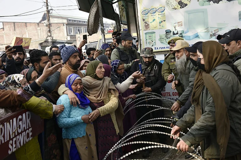 Bereaved relatives trying to get to the blast site and demand the deceased body of Mohammad Shafi Parray, who died in the blast. - Yasir Iqbal