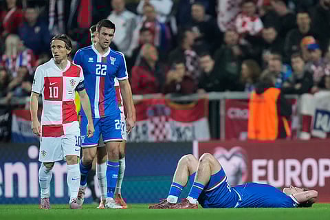 Faroe Islands' Meinhard Olsen lies on the poitch after a foul during a World Cup 2026 group L qualifying soccer match between Croatia and Faroe Islands in Rijeka, Croatia.