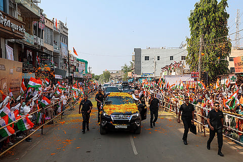 Prime Minister Narendra Modi waves at supporters during a roadshow, at Dediapada in Narmada district, Gujarat. 