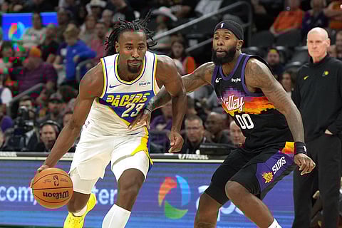 Indiana Pacers guard Aaron Nesmith (23) drives against Phoenix Suns forward Royce O'Neale (00) during the second half of an NBA basketball game in Phoenix. 