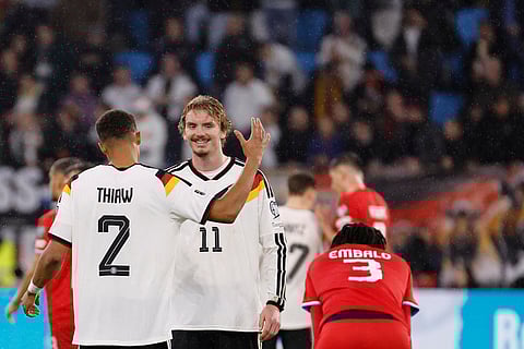 Germany's Nick Woltemade, center, and Germany's Malick Thiaw, left, celebrate their win during the 2026 World Cup group A qualifying soccer match between Luxembourg and Germany in Luxembourg.