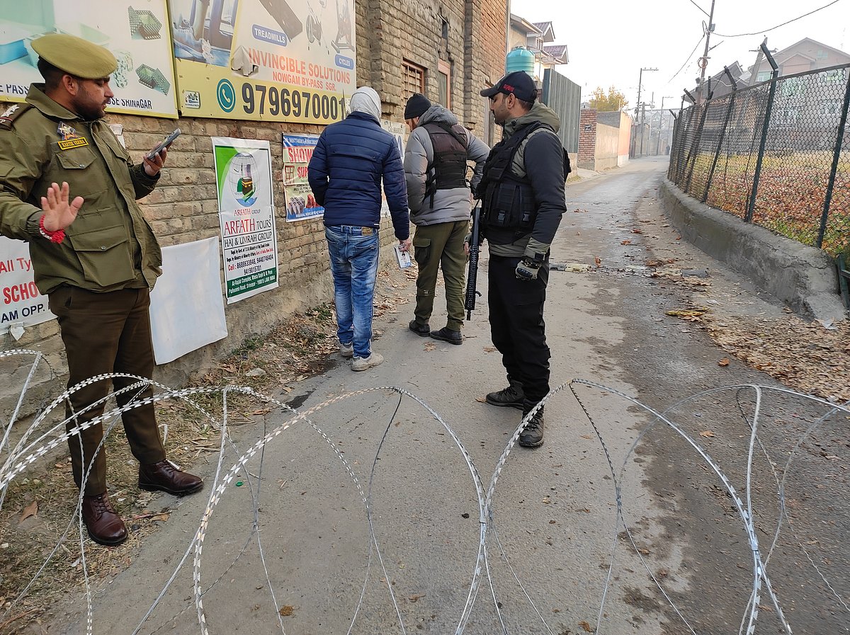 Yasir Iqbal : Security personnel stand guard near the blast site inside Nowgam police station in Srinagar.