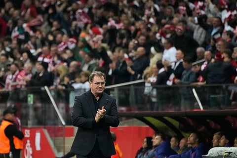 Poland coach Jan Urban reacts after Poland's Jakub Kaminski scored the opening goal during a World Cup 2026 group G qualifying soccer match between Poland and the Netherlands in Warsaw.