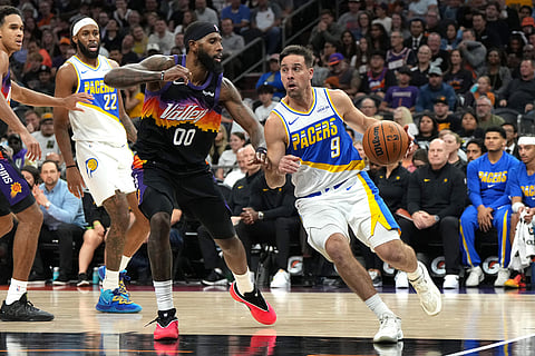 Indiana Pacers guard T.J. McConnell (9) drives past Phoenix Suns forward Royce O'Neale (00) during the second half of an NBA basketball game, in Phoenix. 