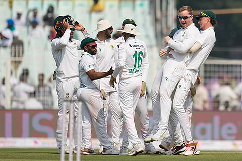 South Africa's Simon Harmer, second right, celebrates with teammates after the dismissal of India's Washington Sundar on the second day of the first cricket test match between India and South Africa in Kolkata.